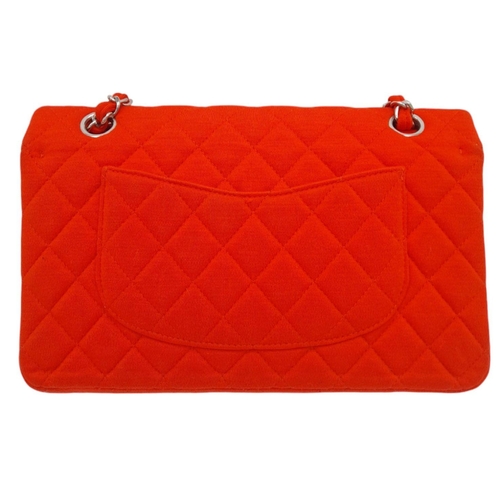 12 - A Chanel Red Jersey Quilted Double Flap Bag. Diamond quilted jersey knit fabric in red, silver-toned... 