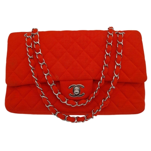 12 - A Chanel Red Jersey Quilted Double Flap Bag. Diamond quilted jersey knit fabric in red, silver-toned... 