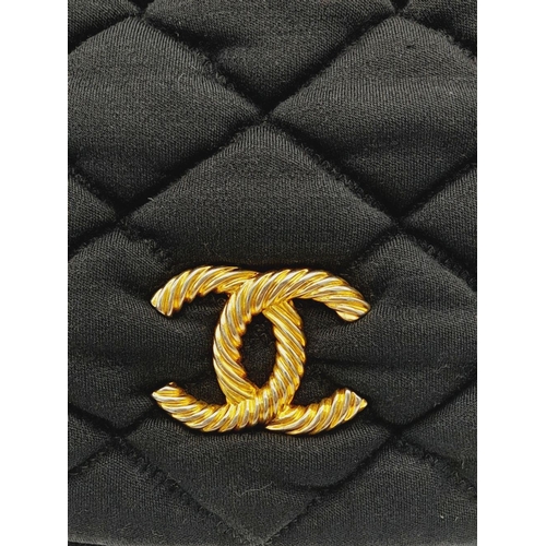 19 - A Chanel Bubble Quilted Flap Bag. Black quilted fabric exterior with gold-toned hardware, CC logo, d... 