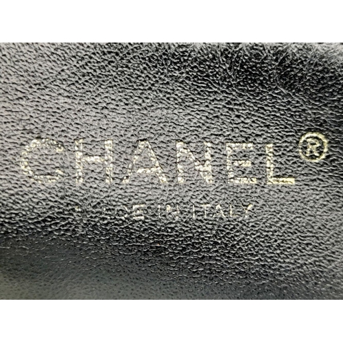 19 - A Chanel Bubble Quilted Flap Bag. Black quilted fabric exterior with gold-toned hardware, CC logo, d... 