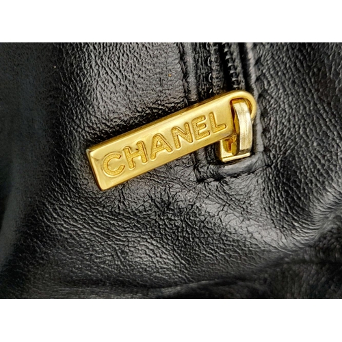 19 - A Chanel Bubble Quilted Flap Bag. Black quilted fabric exterior with gold-toned hardware, CC logo, d... 