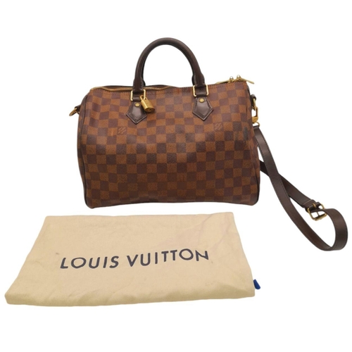 26 - A Louis Vuitton Speedy Bag. Damier Ebene canvas exterior with gold-toned hardware, two rolled leathe... 