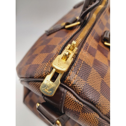 26 - A Louis Vuitton Speedy Bag. Damier Ebene canvas exterior with gold-toned hardware, two rolled leathe... 