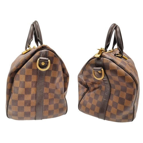 26 - A Louis Vuitton Speedy Bag. Damier Ebene canvas exterior with gold-toned hardware, two rolled leathe... 