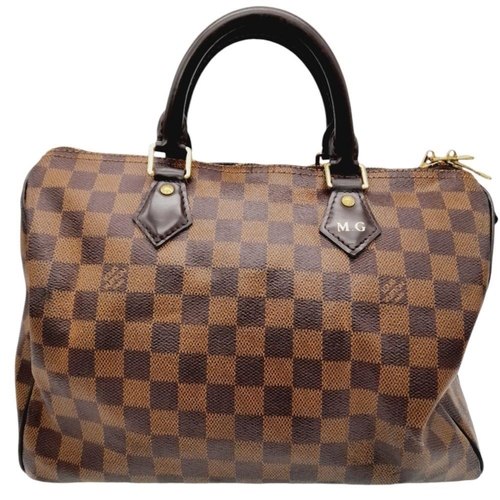 26 - A Louis Vuitton Speedy Bag. Damier Ebene canvas exterior with gold-toned hardware, two rolled leathe... 