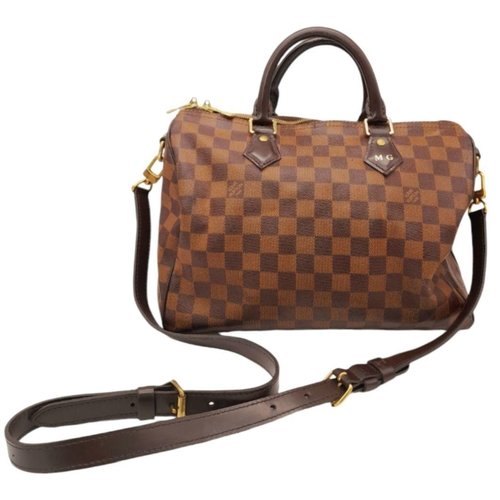 26 - A Louis Vuitton Speedy Bag. Damier Ebene canvas exterior with gold-toned hardware, two rolled leathe... 