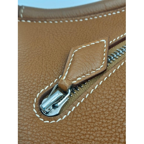 47 - An Hermes Togo Cacahuete Bag. Brown leather exterior, silver-toned hardware and a single circular le... 