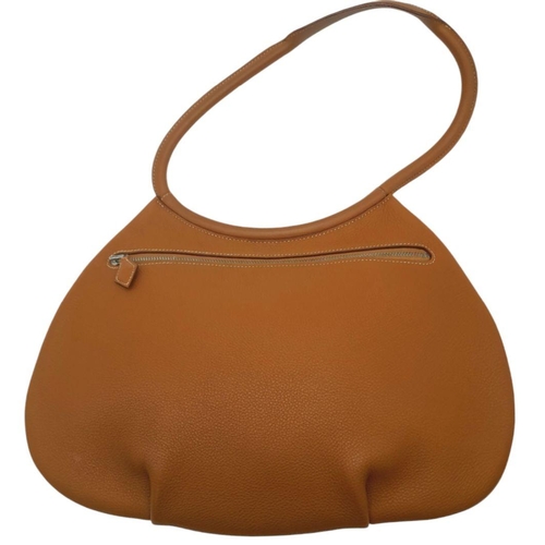 47 - An Hermes Togo Cacahuete Bag. Brown leather exterior, silver-toned hardware and a single circular le... 