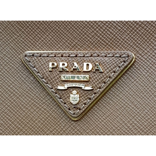 54 - A Prada Camel Large Bag. Leather exterior with gold-toned hardware, two rolled leather handles, four... 