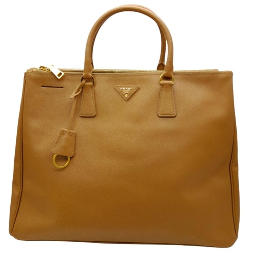 54 - A Prada Camel Large Bag. Leather exterior with gold-toned hardware, two rolled leather handles, four... 