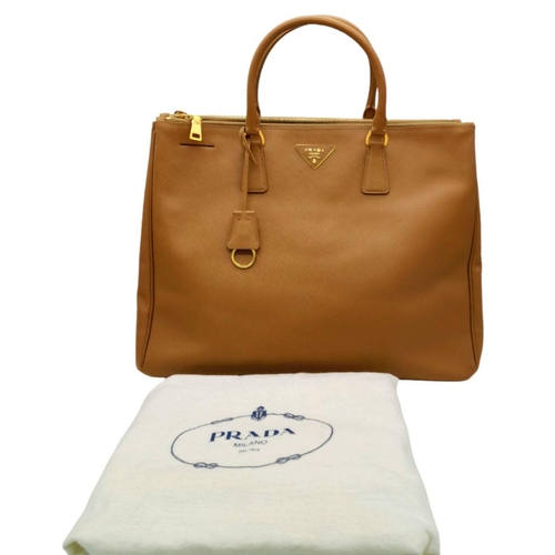 54 - A Prada Camel Large Bag. Leather exterior with gold-toned hardware, two rolled leather handles, four... 