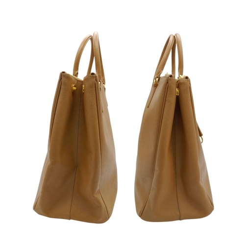 54 - A Prada Camel Large Bag. Leather exterior with gold-toned hardware, two rolled leather handles, four... 