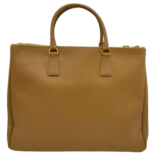 54 - A Prada Camel Large Bag. Leather exterior with gold-toned hardware, two rolled leather handles, four... 