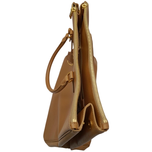 54 - A Prada Camel Large Bag. Leather exterior with gold-toned hardware, two rolled leather handles, four... 