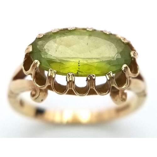 21 - Stunning 14 carat GOLD and PERIDOT RING. Having a large oval cut PERIDOT set to top in beautiful cra... 