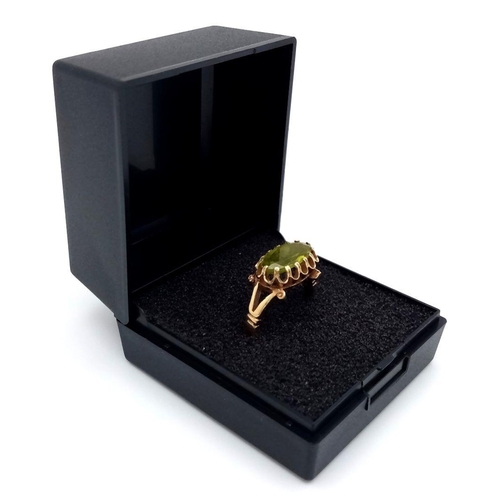 21 - Stunning 14 carat GOLD and PERIDOT RING. Having a large oval cut PERIDOT set to top in beautiful cra... 