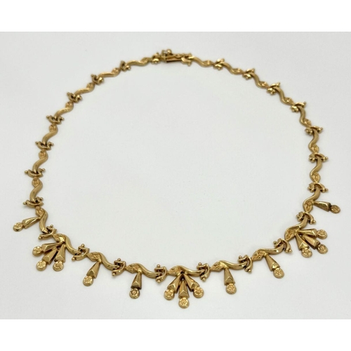 5 - AN 18K GOLD DESIGNER NECKLACE BASED ON THE 