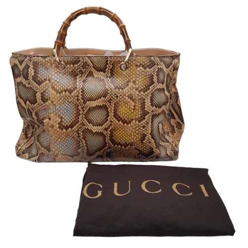 33 - A Gucci Python Bamboo Top Handle Bag. Python skin exterior in shades of brown and beige, gold-toned ... 