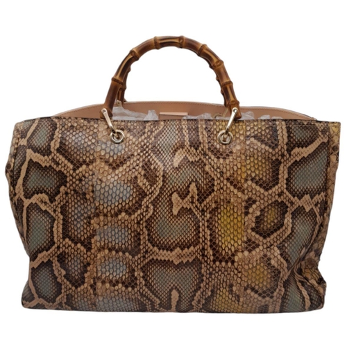 33 - A Gucci Python Bamboo Top Handle Bag. Python skin exterior in shades of brown and beige, gold-toned ... 