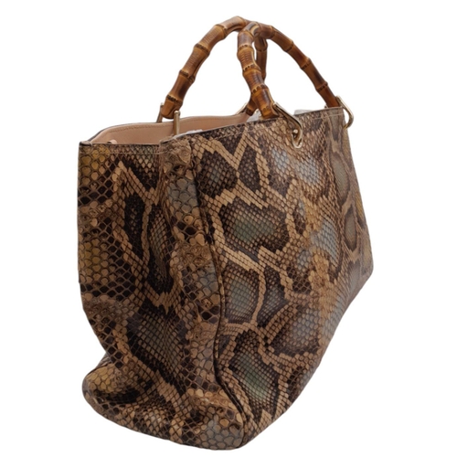 33 - A Gucci Python Bamboo Top Handle Bag. Python skin exterior in shades of brown and beige, gold-toned ... 