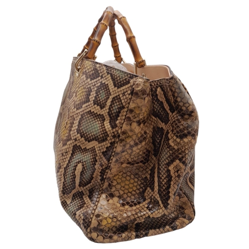 33 - A Gucci Python Bamboo Top Handle Bag. Python skin exterior in shades of brown and beige, gold-toned ... 