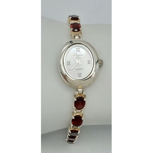 633 - Ladies Sterling Silver Garnet Set Bracelet Watch by Precious Time. 18mm Case. Set with 6mm Oval Cut ... 