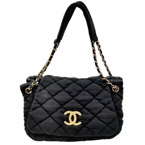 19 - A Chanel Bubble Quilted Flap Bag. Black quilted fabric exterior with gold-toned hardware, CC logo, d... 