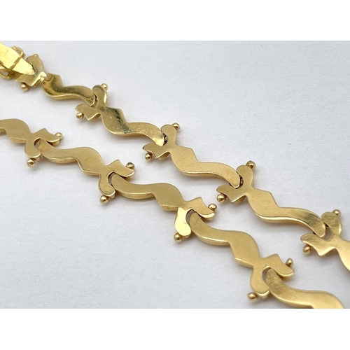 5 - AN 18K GOLD DESIGNER NECKLACE BASED ON THE 