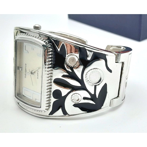 150 - An unusual, ladies, vintage, bracelet watch, by Indulgence, rectangular case, silver tone and black ... 