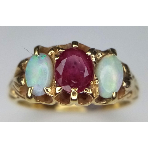 16 - A Vintage 18K Yellow Gold Opal and Ruby Ring. Central ruby with a colour-play opal either side. Size... 