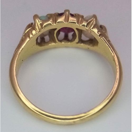 16 - A Vintage 18K Yellow Gold Opal and Ruby Ring. Central ruby with a colour-play opal either side. Size... 