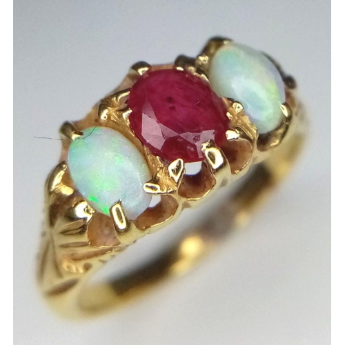 16 - A Vintage 18K Yellow Gold Opal and Ruby Ring. Central ruby with a colour-play opal either side. Size... 