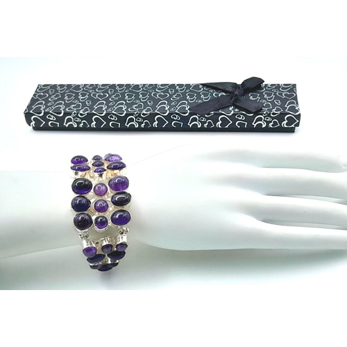 164 - A sophisticated bracelet with large natural amethyst cabochons. Length: 17-22 cm, weight: 56.6 g. In... 