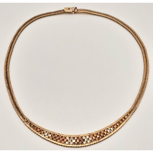 17 - A Glamourous Tri-Colour 9K Gold Necklace. Mesh design in herringbone form. 42cm length. 31g.