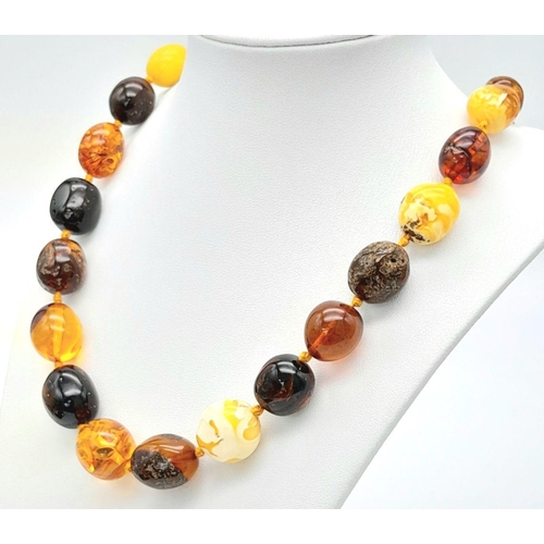 44 - A Vintage Amber Necklace. Honey, white butterscotch and Red Beads create this amber masterpiece. 62c... 