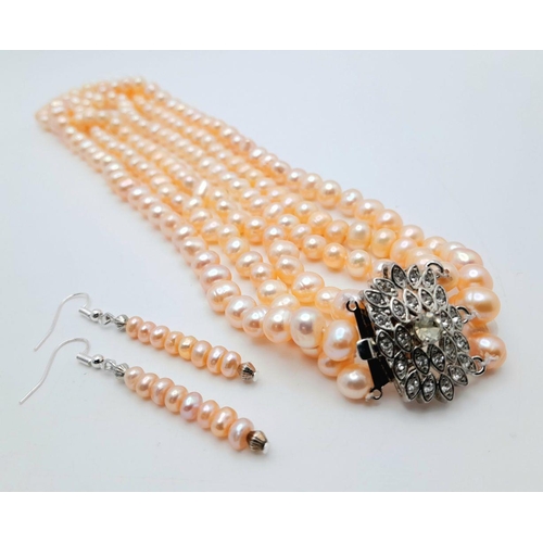 94 - A vintage three strand cultured natural pink pearls necklace with a stunning clasp loaded with cubic... 