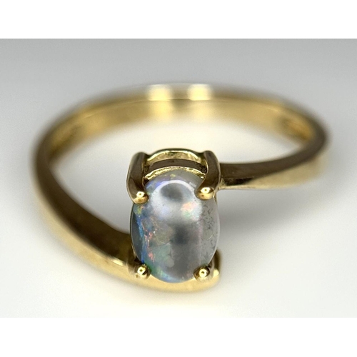 175 - Attractive 9 carat GOLD and OPAL RING. Having Oval BLUE OPAL set to top in Stylish crossover mount. ... 