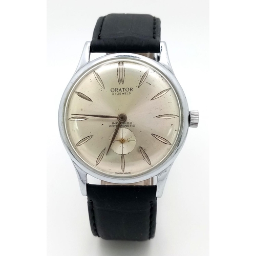 57 - A Vintage Orator 21 Jewels Gents Watch. Black leather strap. 
Stainless steel case - 37mm. Silver to... 