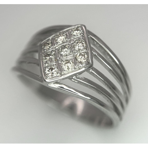 248 - An 18K White Gold Diamond Ring. Skeleton form with a trillion nine diamond centre. Size Q. 5.12g tot... 