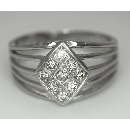 248 - An 18K White Gold Diamond Ring. Skeleton form with a trillion nine diamond centre. Size Q. 5.12g tot... 