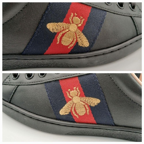 253 - A Pair of Gucci Men's Ace Embroidered Sneakers. Black leather with a gold embroidered bee to side. I... 