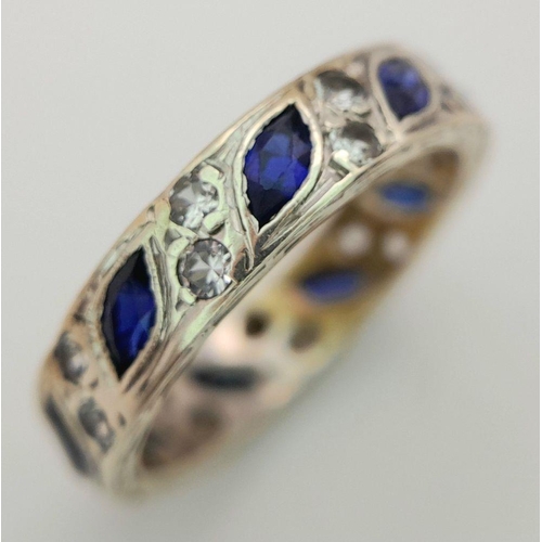 292 - A 9K WHITE GOLD BLUE AND WHITE SAPPHIRE SET BAND RING 3.2G , RING SIZE K.

REF: SC 1020