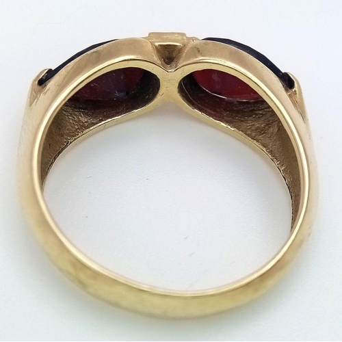 304 - AN 14K GOLD DESIGNER RING WITH UNUSUAL GARNET STONES  .            5.4gms    size Q