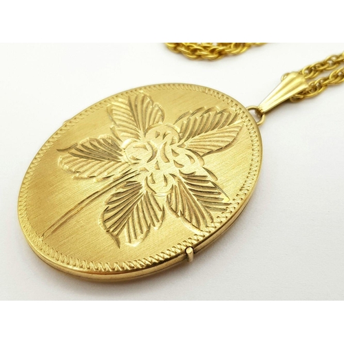 67 - A VINTAGE 9K GOLD LOCKET WITH FLORAL DECORATION AND ON A 58cms 9K GOLD TWIST CHAIN .   20.6gms