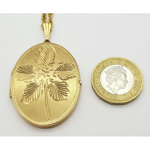 67 - A VINTAGE 9K GOLD LOCKET WITH FLORAL DECORATION AND ON A 58cms 9K GOLD TWIST CHAIN .   20.6gms