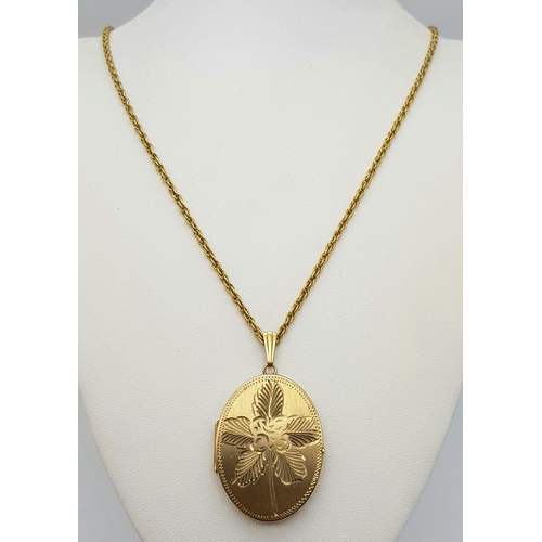 67 - A VINTAGE 9K GOLD LOCKET WITH FLORAL DECORATION AND ON A 58cms 9K GOLD TWIST CHAIN .   20.6gms