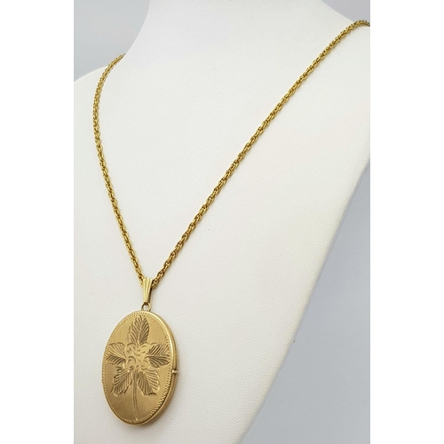 67 - A VINTAGE 9K GOLD LOCKET WITH FLORAL DECORATION AND ON A 58cms 9K GOLD TWIST CHAIN .   20.6gms