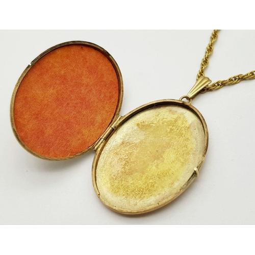 67 - A VINTAGE 9K GOLD LOCKET WITH FLORAL DECORATION AND ON A 58cms 9K GOLD TWIST CHAIN .   20.6gms