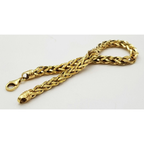 74 - AN 18K GOLD INTERLINK TWIST BRACELET WITH LOBSTER CLASP  .   8.1gms     20cms