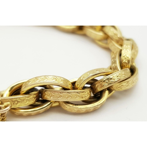 81 - A VINTAGE 9K GOLD HEAVY LINK BRACELT WITH EACH LINK BEING DECORATED AND HAVING AN ORNATE HEART PADLO... 